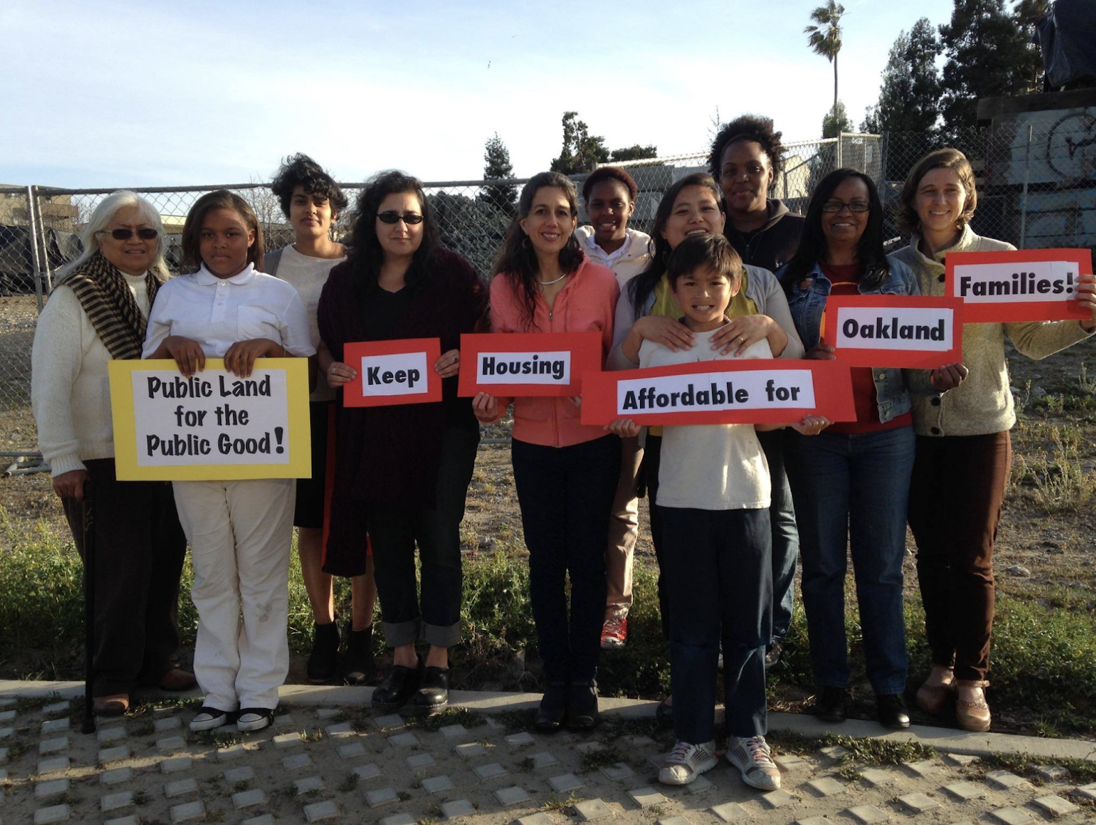 A group of TAYhub members holding handmade signs that collectively read 
