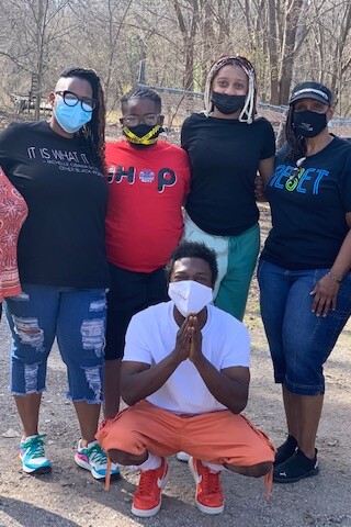 Seven BIPOC people pose for a picture while wearing masks in Sandbranch, Texas.